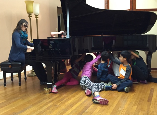 Student detectives get an unforgettable experience listening to teacher Victoria Suchodoloski play on a Steinway grand, under the piano!