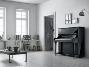 Upright piano against inner wall of room