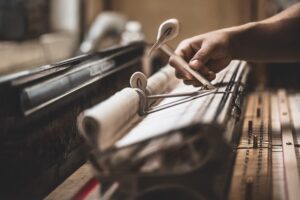 Steinway craftsperson working with a piano's action