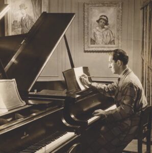 Photo of Jazz legend George Gershwin composing at his Steinway.