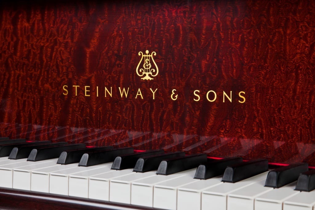 Photo of Steinway & Sons logo on mahogany grand piano