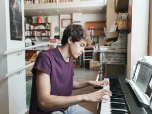 Young man playing digital piano