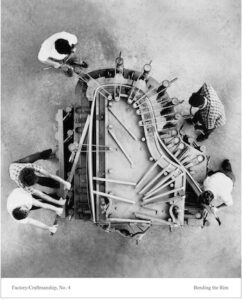 Aerial photo of Steinway craftspeople building a Hard Rock Maple rim for a grand piano.